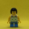 LEGO Child - Girl, White Halter Top Minifigure with Green Apples and Lime Spots, Medium Blue Short Legs, Black Bob Cut Hair, Freckles - Image 2